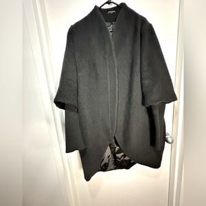 Universal Standard winter coat with 3 quarter sleeve then knit sleeve.